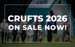 Official Crufts 2026 Hospitality Packages are available now from VIP Matchdays. The image features the event logo and white text on a dark overlay above a photo of dog handlers and their dogs in the main arena.